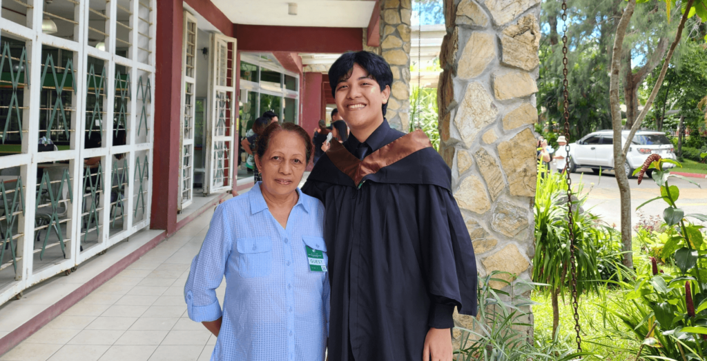 Genesis with his grandmother during his graduation.