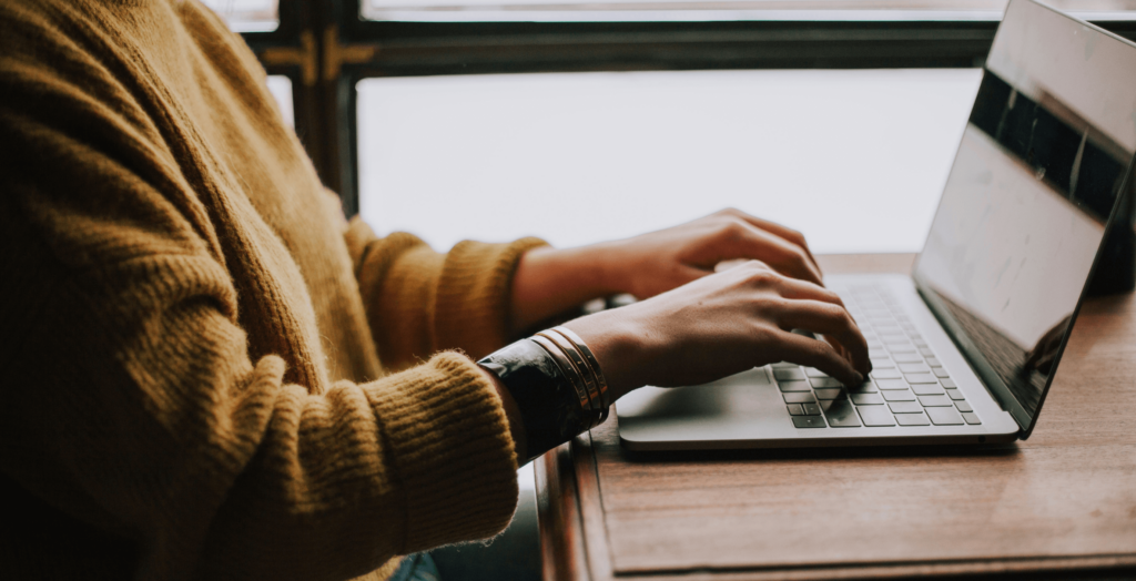 Person typing on a computer.