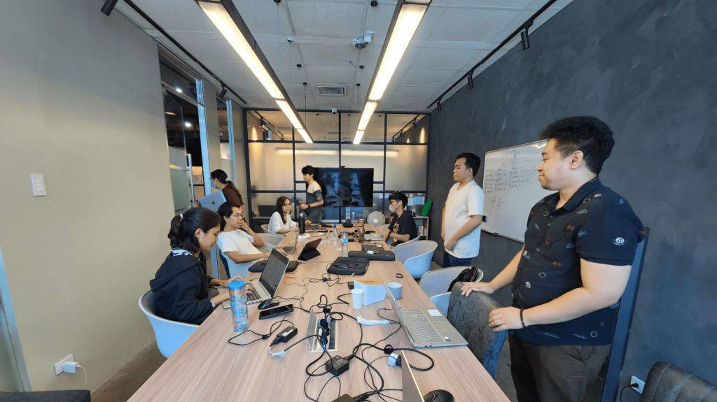 A group of people gathered around a table in a conference room.