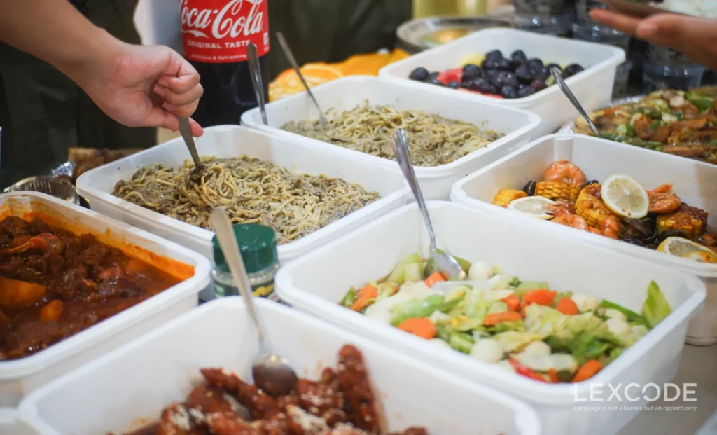 A variety of festive dishes are organized neatly on a table with drinks at the side.