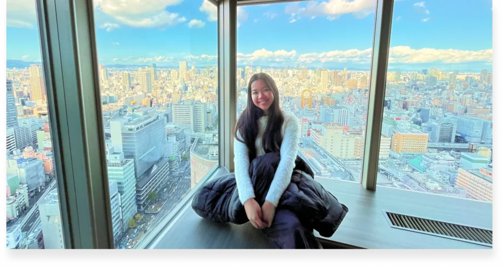 One of Lexcode’s translation project managers poses with a city backdrop behind her during a client visit.