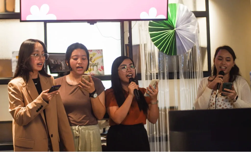 Lexcode AI QA team members singing karaoke together at the company year-end celebration.