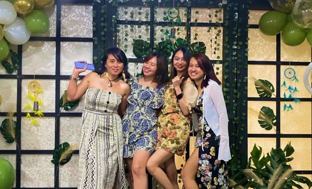 Lexcode's admin, HR, accounting officer, and general manager posing together at a company event.
