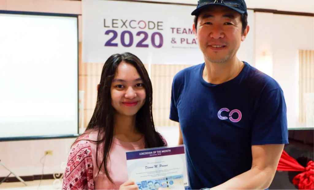 Lexcode CEO presenting an award to an employee during a company recognition event.