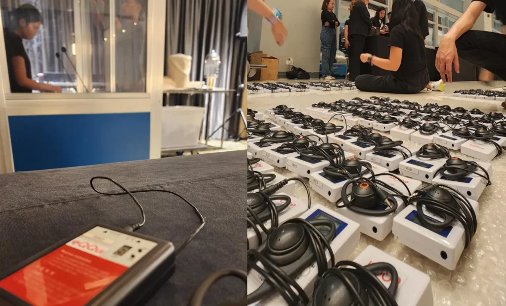 Simultaneous interpretation booths and receivers being prepared for an event.