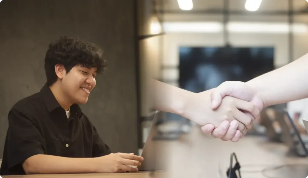 Smiling young Asian man in black shirt shaking hands with colleague in modern office setting