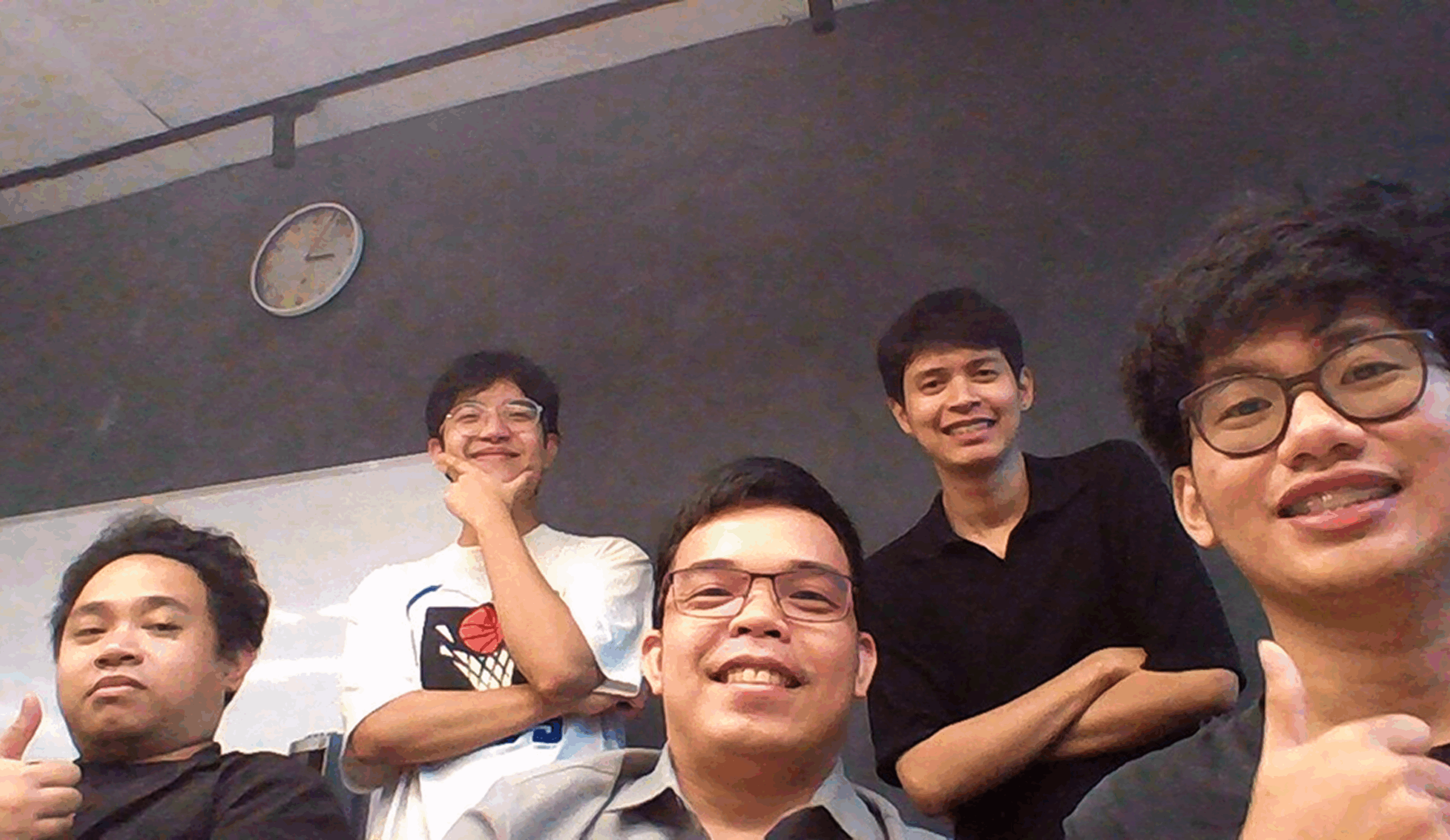 A group of 5 boys smiling widely