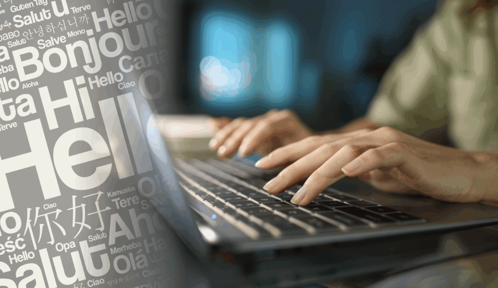Hands typing on a keyboard with multilingual “hello” greetings overlaid, symbolizing translation and global communication.